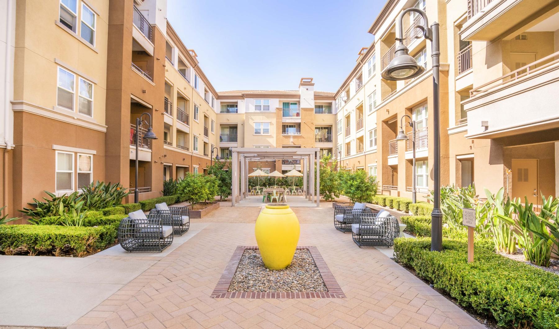 Find your perfect fit at Main Street Village a courtyard with chairs and tables