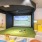 a room with a large screen and chairs