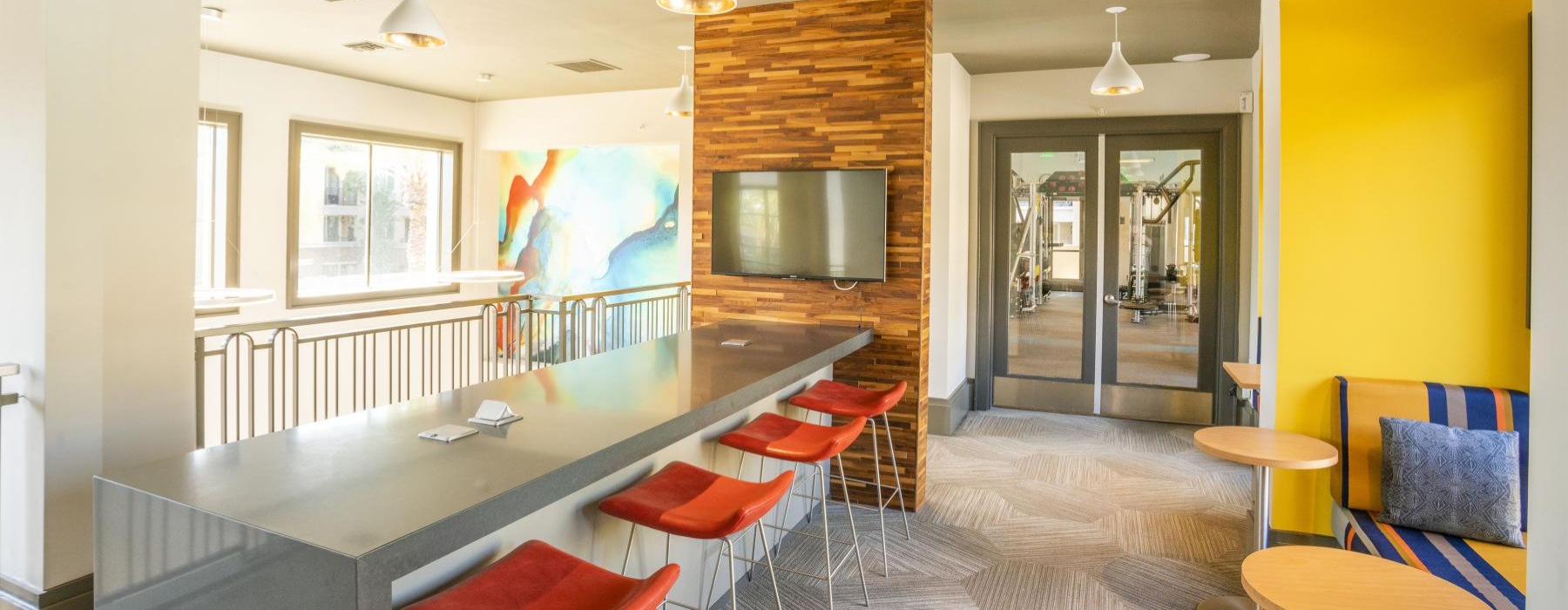 a kitchen with a bar and chairs