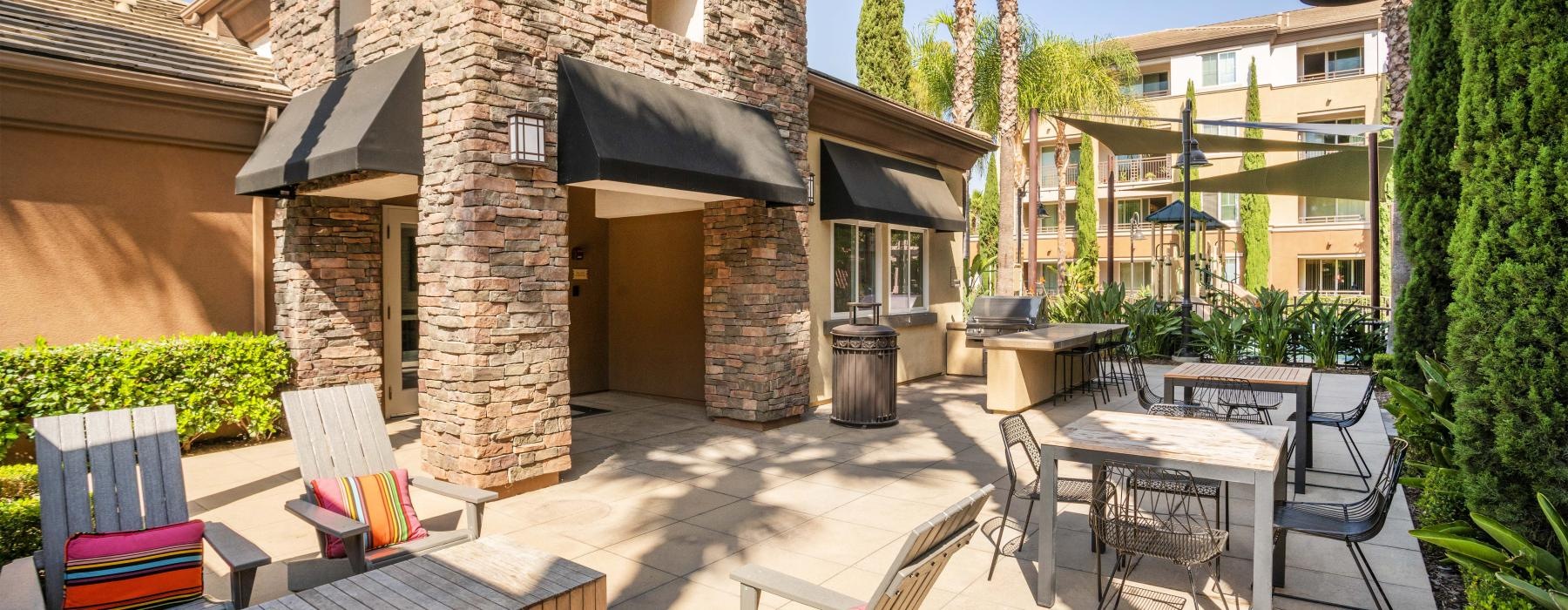 a patio with tables and chairs