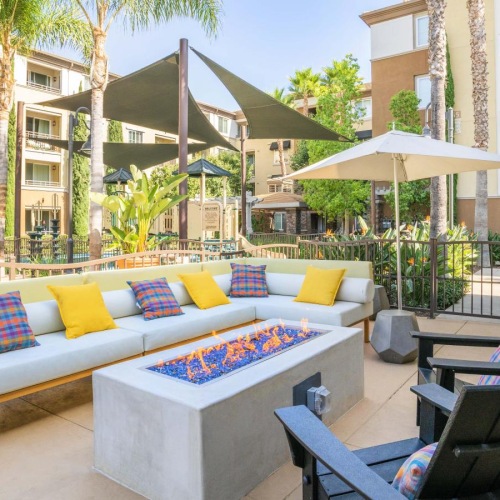 Everything within reach a patio with a couch and chairs